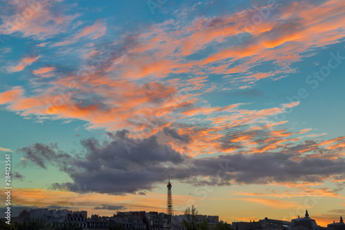 Pink and orange clouds over the Eiffel Tower at sunset