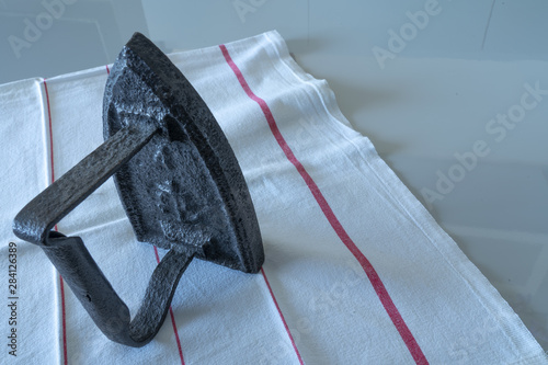 an vintage smoothing ironer object on a table photo