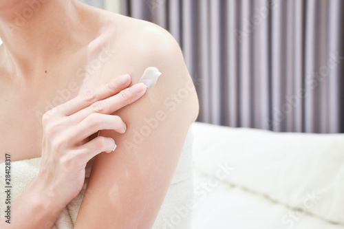 Woman applying arm cream lotion   Hygiene skin body care concept.
