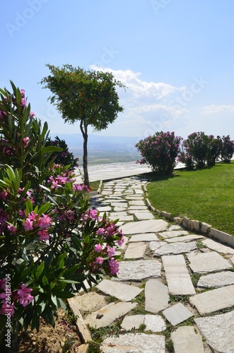 Hierapolis-Pamukkale, Denizli, Turkey. 05/25/2016. Square (park) with trees and flowers. White mountains. Cotton castle. 