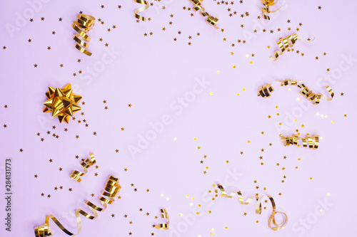 Golden decorations and sparkles on pale purple background
