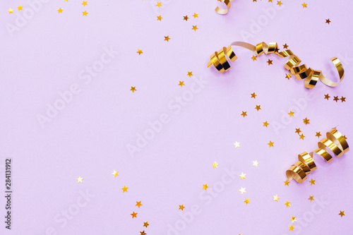 Golden decorations and sparkles on pale purple background