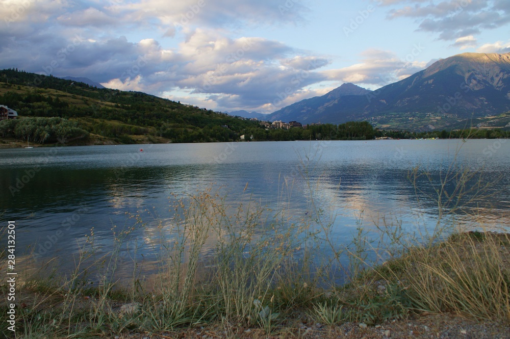 reservoir, artificial lake, manmade lake near Embrun, Hautes alpes, in France. LArge view with the alps in background