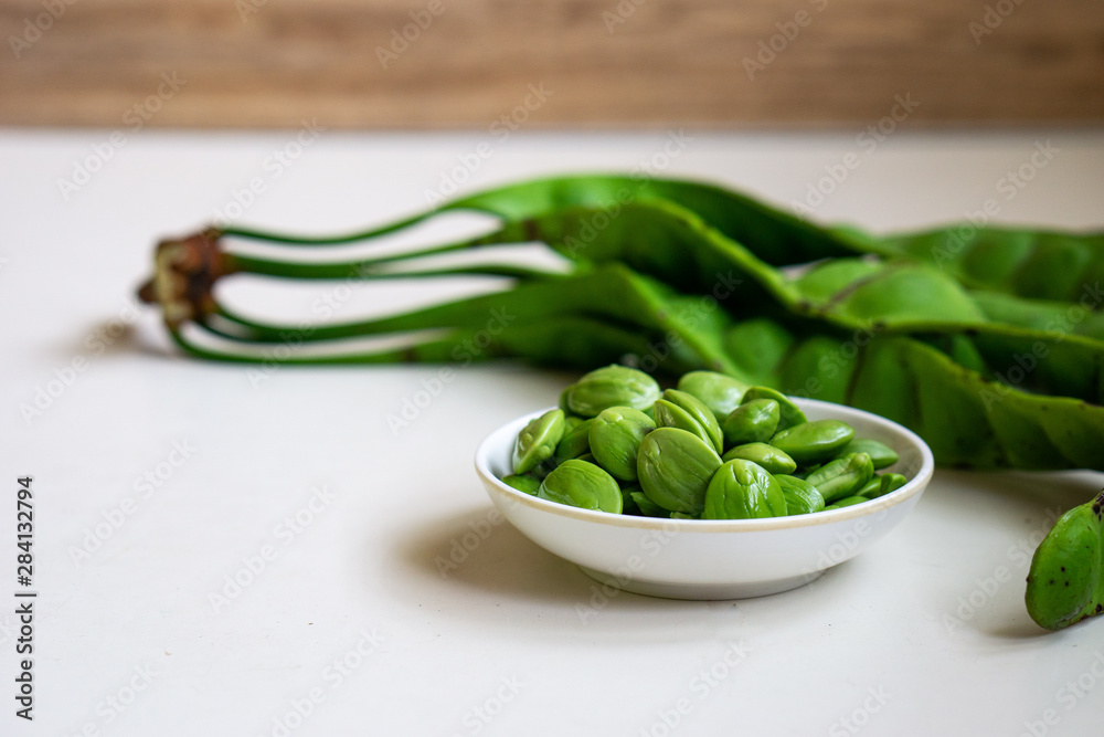 Raw bitter beans or Petai isolated on white background. Selective focus. Raw bitter beans or Petai isolated on white background. Selective focus.