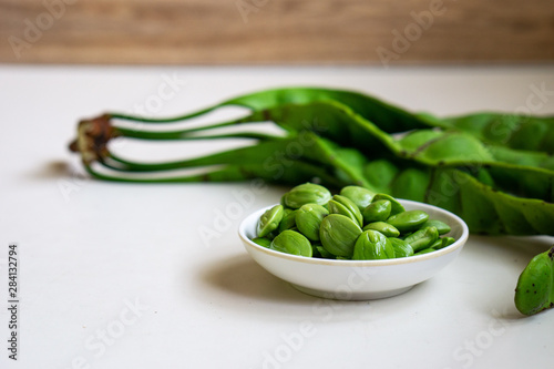 Raw bitter beans or Petai isolated on white background. Selective focus. photo