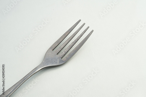 dining fork closeup lies on white background  Cutlery steel fork close up