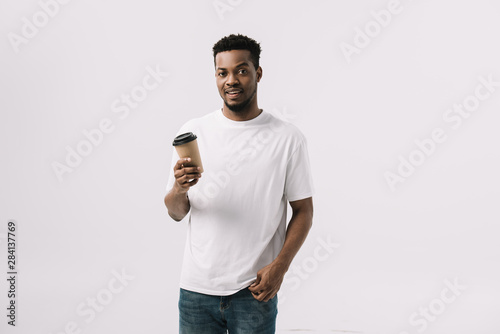 curly african american man holding paper cup isolated on white