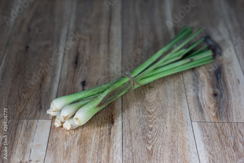 Fresh lemongrass isolated on wooden background. Selective focus.