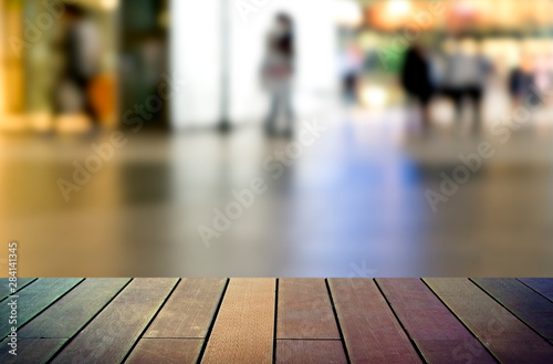 image of wooden table in front of abstract blurred background © wedninth