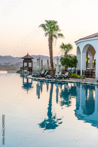 Sharm El Sheikh, Egypt - May 2019: The concept of comfortable rest near the pool. Beautiful swimming pool with a bar in the oriental style.