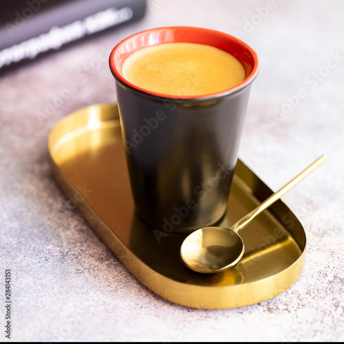 Cup on black coffee Espresso in the black cup. Wake up and cood morning concept. photo