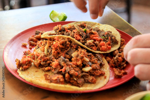 mexican food taco campechano with meat and lime 