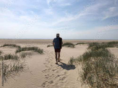 Man walking on beach, Fanoe, Jutland, Denmark photo