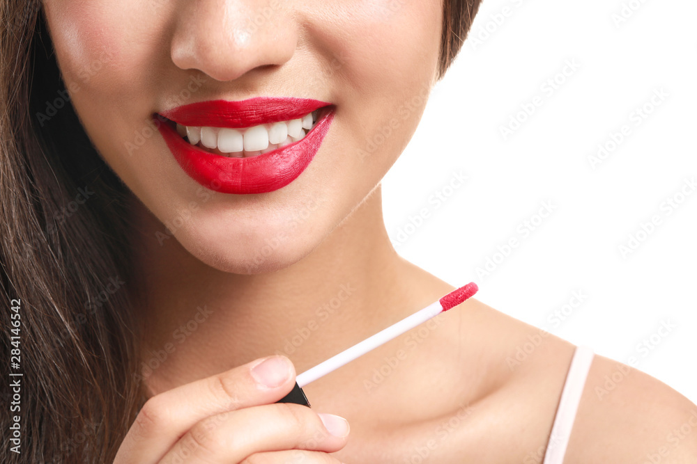 Beautiful young woman with lipstick on white background, closeup Beautiful young woman with lipstick on white background, closeup