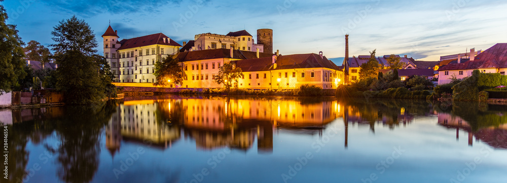 Jindrichuv Hradec Castle by night. Reflection in the water. Czech Republic
