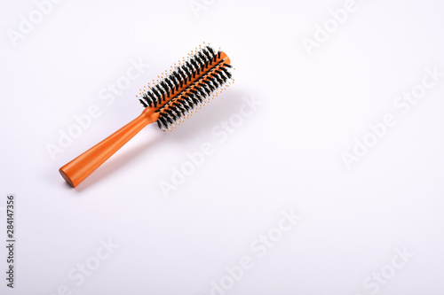 Hairbrush on the white background with copy space