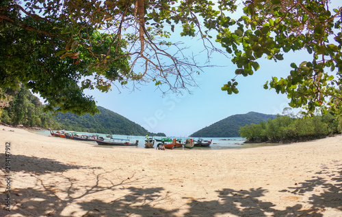 tour boats waiting tourism at mai ngam beach mu ko surin national park attraction chumphon province in thailand photo