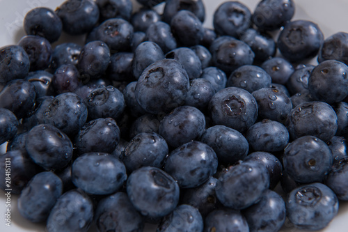  Clean freshly picked blueberries on white plate - close up studio shot. ( Ingredients: Antioxidants , Vitamin C, Antioxidant)
