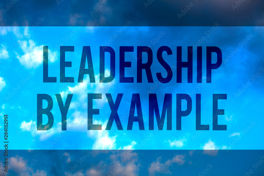 Handwriting text Leadership By Example. Concept meaning Becoming role model for people Have great qualities Multiline text desktop natural blue sky cloudy background send messages