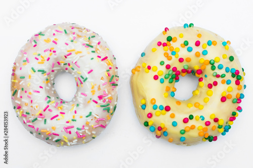Two donuts with bright sprinkles on a isolated background, food concept
