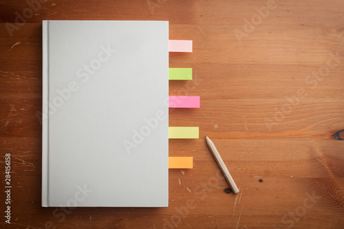 A blank cover book and a pencil on a wooden table