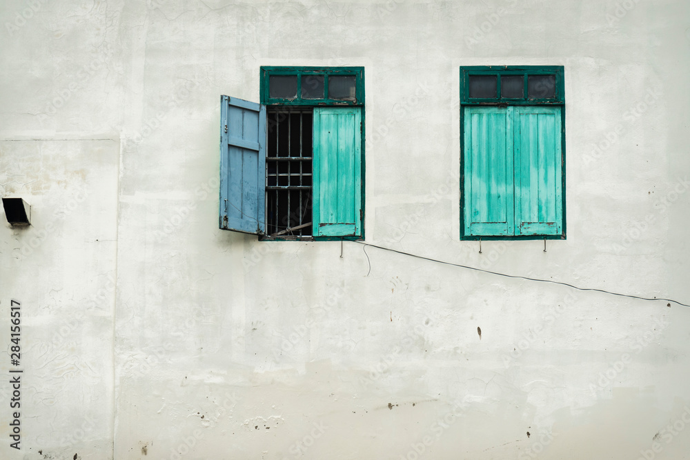 Fototapeta premium Old two green windows and wall background photo