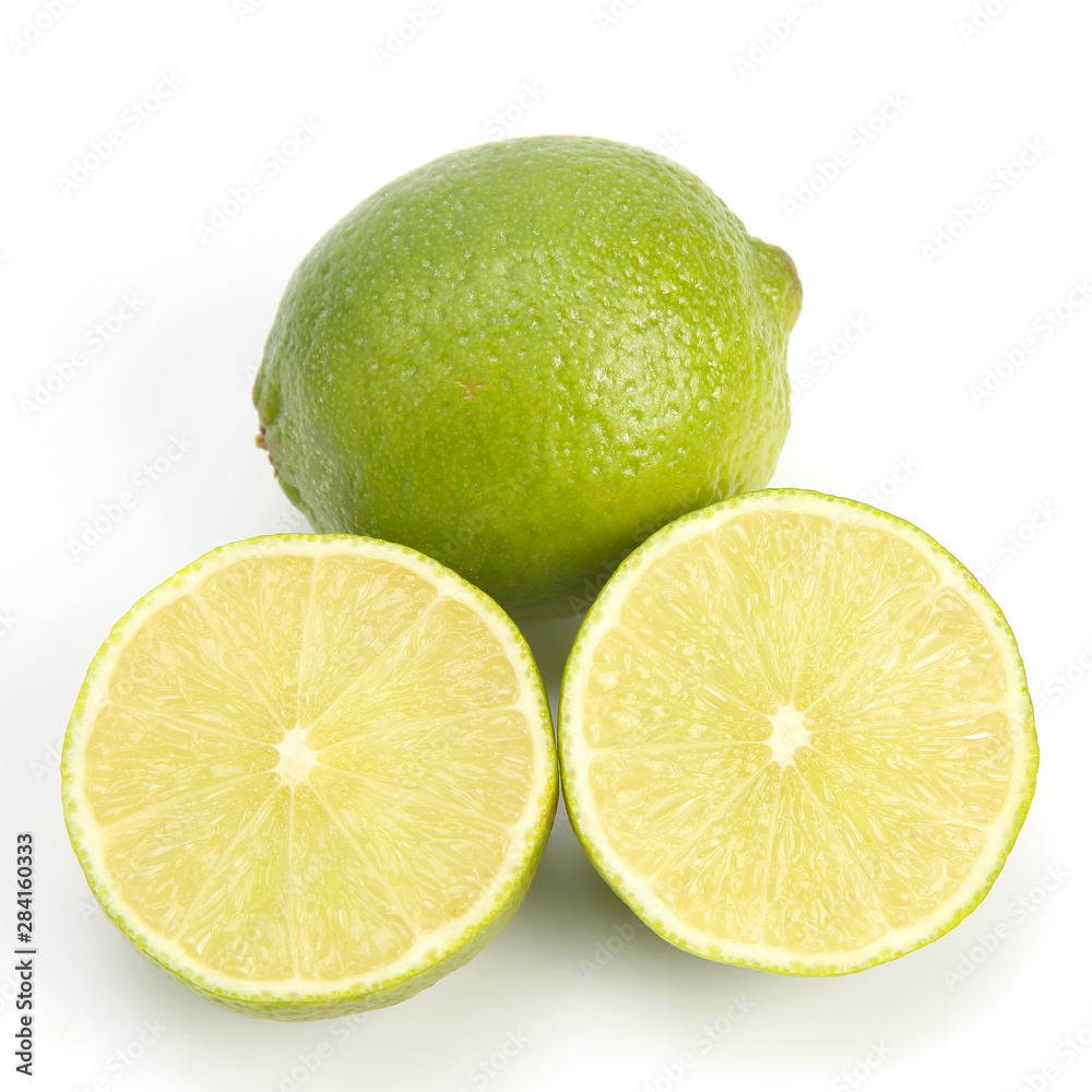 Cut citrus fruit of green lemon on white background