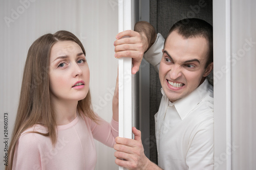 Concept violence, attractive woman in horror trying to hide from crazy photo