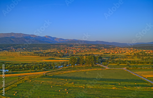 Aerial view of the fields near Sinj with hay bales in the countryside, Croatia