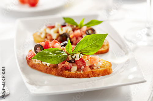 Italian Appetizer Bruschetta with Tomatoes, Cheese and Basil