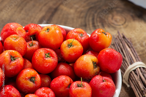 acerola fruit with rustic wood background