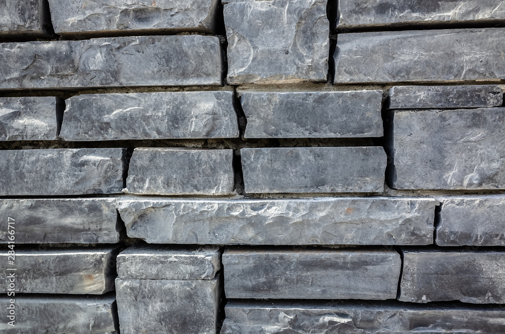 Naklejka premium gray brick wall with rough texture