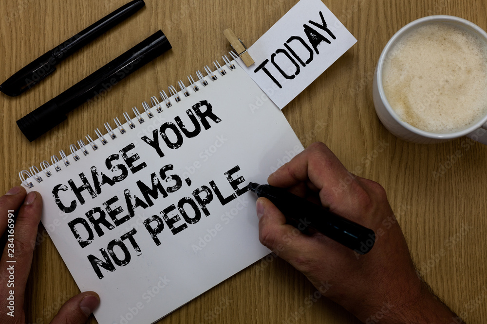 Text sign showing Chase Your Dreams, Not People. Conceptual photo Do not follow others chasing goals objectives Paperclip retain written notepad hand hold marker coffee black pen on woody desk Text sign showing Chase Your Dreams, Not People. Conceptual photo Do not follow others chasing goals objectives Paperclip retain written notepad hand hold marker coffee black pen on woody desk