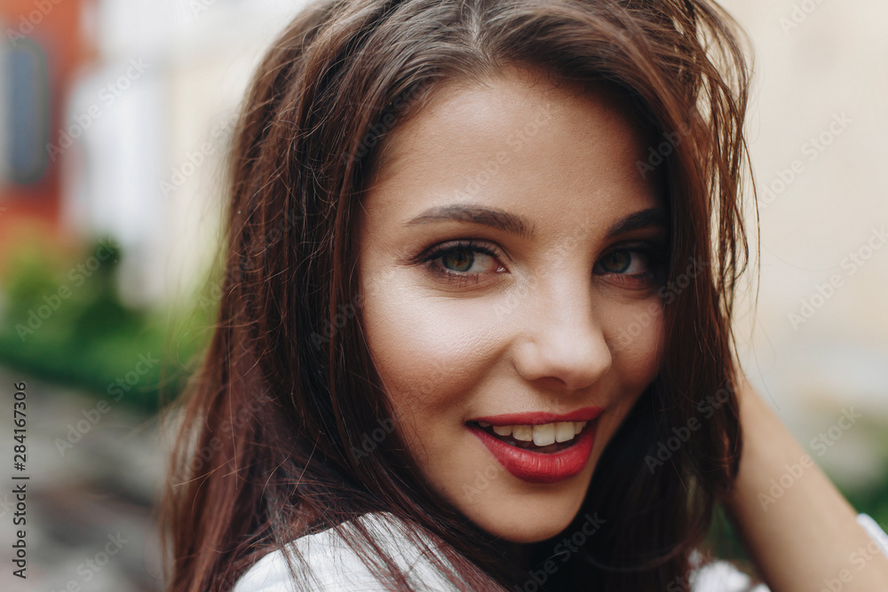 Headshot portrait of beautiful woman with long brown hair. Model looking at camera, sexy look.