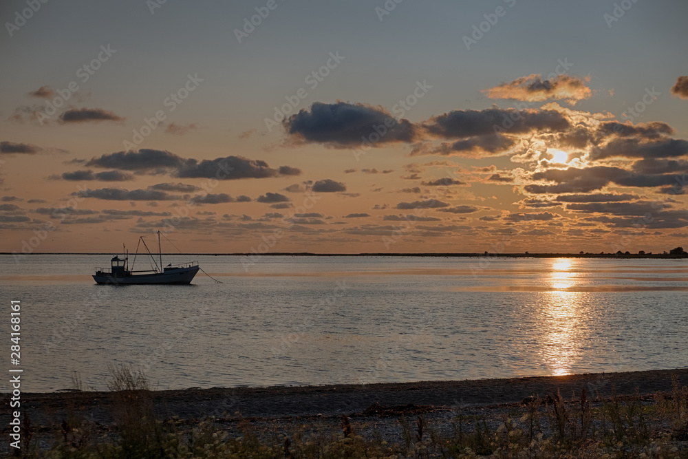 sunset on the sea with boat