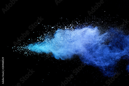 Blue powder explosion on black background. Colored cloud. Colorful dust explode. Paint Holi. © piyaphong