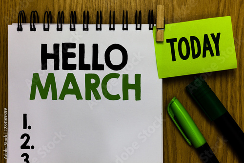 Text sign showing Hello March. Conceptual photo musical composition usually in duple or quadruple with beat Notebook clothespin holding reminder markers expressing ideas wood table photo