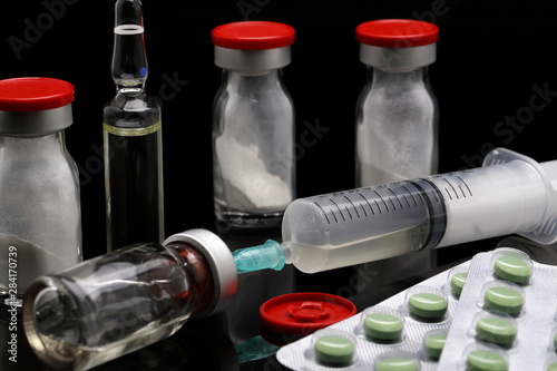 cortisone treatment, syringe and cortisone bottles photo