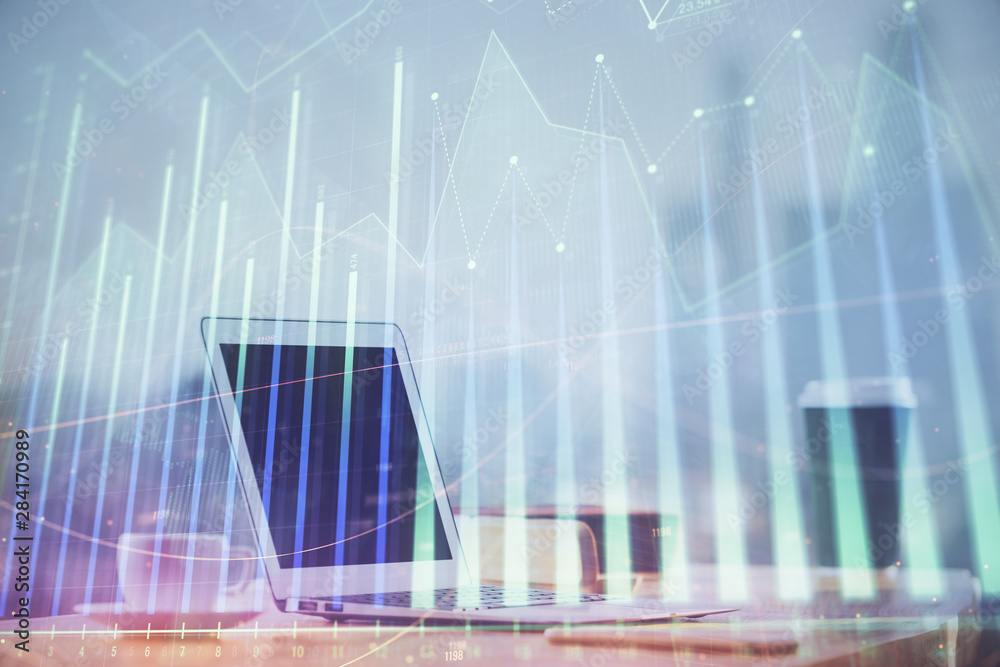 Forex graph hologram on table with computer background. Multi exposure. Concept of financial markets. Forex graph hologram on table with computer background. Multi exposure. Concept of financial markets.