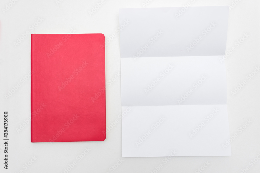 Office worker's Desk, red notebook, letter or white piece of paper, background, copy space, for recording, text, close up, top view