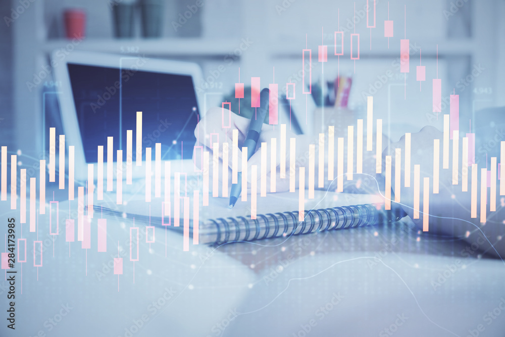 Financial graph displayed on woman's hand taking notes background. Concept of research. Double exposure Financial graph displayed on woman's hand taking notes background. Concept of research. Double exposure