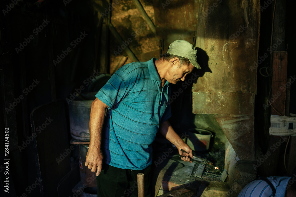 Blacksmiths working in a workshop Blacksmiths working in a workshop