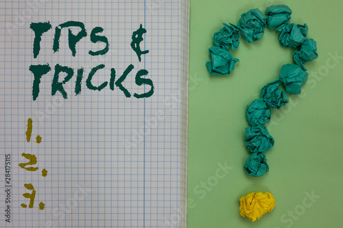 Text sign showing Tips and Tricks. Conceptual photo Steps Lifehacks Handy advice Recommendations Skills Notebook paper crumpled papers forming question mark green background photo
