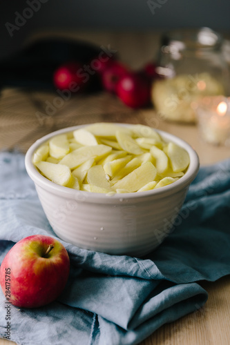 Sliced and peeled apples in bowl of lemon water, ready for bakin photo