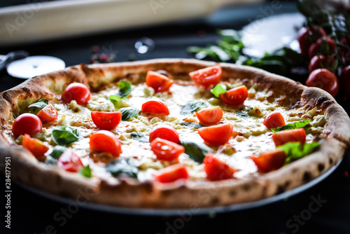 fresh italian pizza with mozzarella, cherry tomatoes & basil