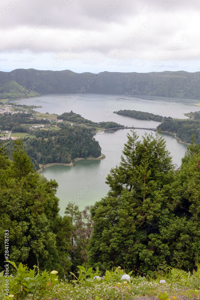Beautiful views of the twin lake of Seti Sidadish, Lagoa das Sete Cidades in cloudy weather. Panorama. Attractions on the island of San Miguel, Portugal. Travel to the Azores.