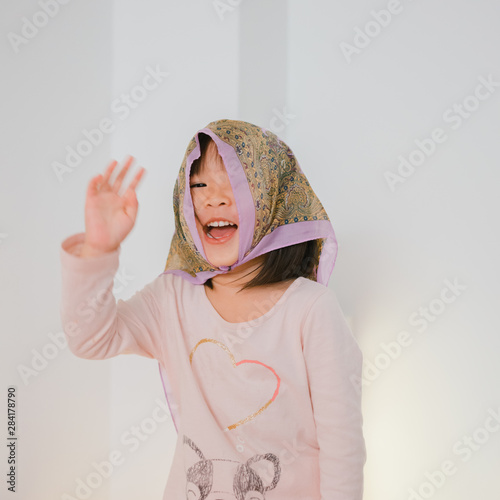 portrait of little girl playing with a kerchief