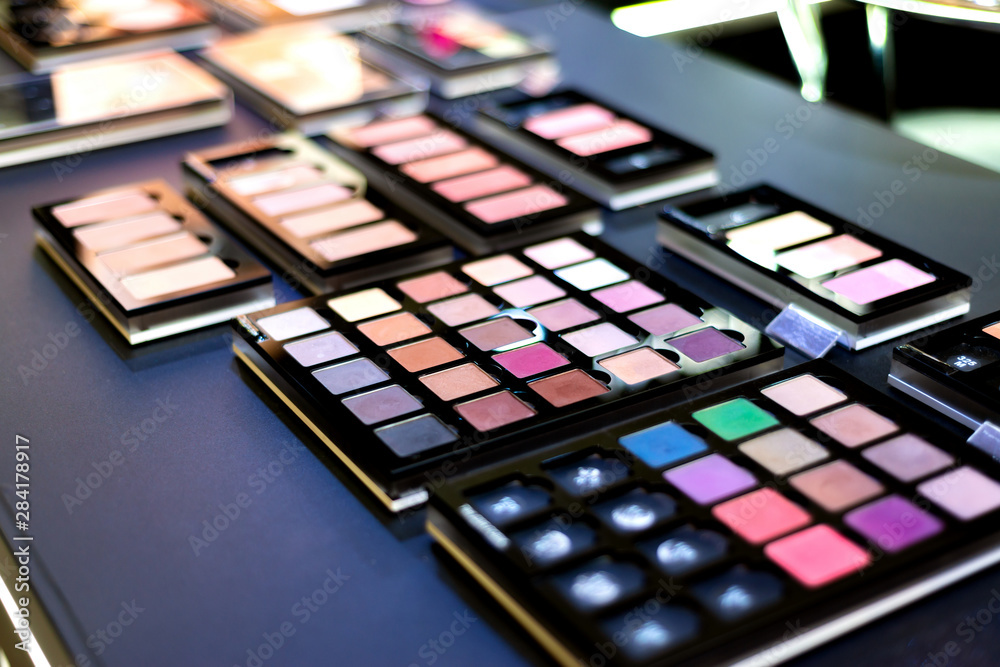 Exhibition of cosmetics in a boutique, eyeshadow on sale in a store. Colorful and gorgeous colors for professional makeup. Exhibition of cosmetics in a boutique, eyeshadow on sale in a store. Colorful and gorgeous colors for professional makeup.