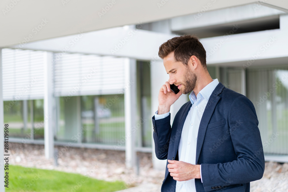 Businessman talking on cell phone outdoors Businessman talking on cell phone outdoors
