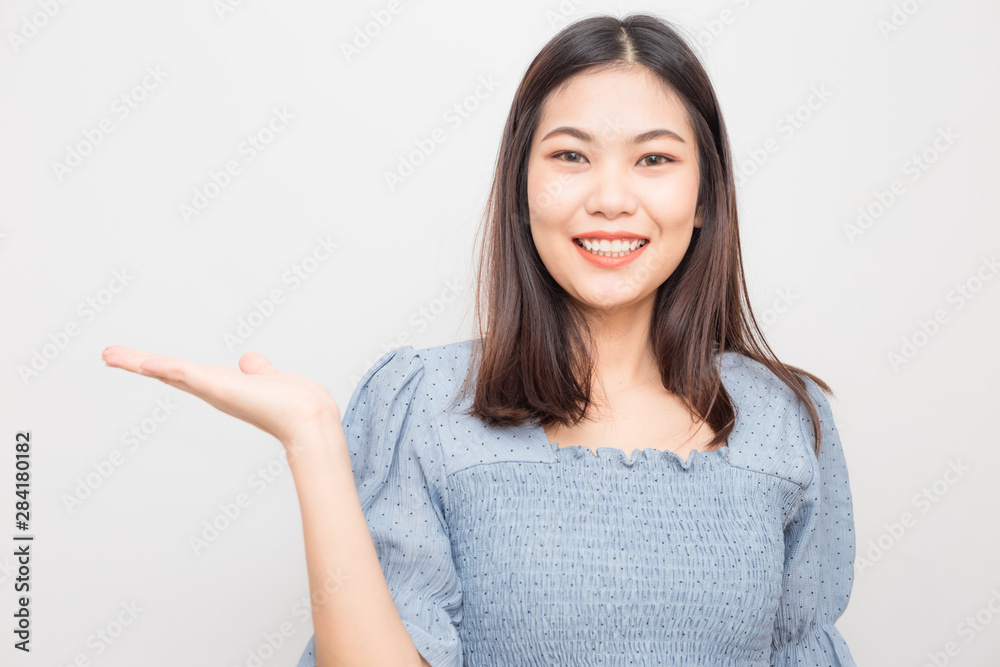 Beautiful smiling asian women show welcome hand gesture Beautiful smiling asian women show welcome hand gesture